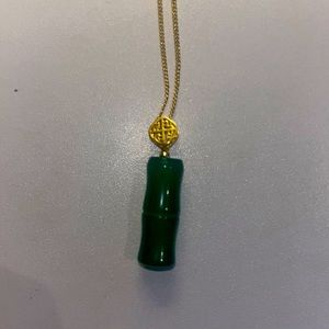 gold necklace with jade bamboo shaped pendant